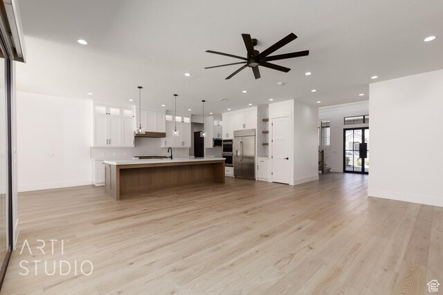 2832 E Stonedale Dr, St George, UT 84790 - kitchen featuring appliances with stainless steel finishes, open floor plan, light countertops, light wood-style floors, and recessed lighting