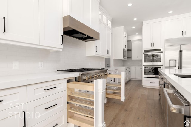 2832 E Stonedale Dr, St George, UT 84790 - kitchen featuring stainless steel appliances, under cabinet range hood, recessed lighting, light wood finished floors, and white cabinets