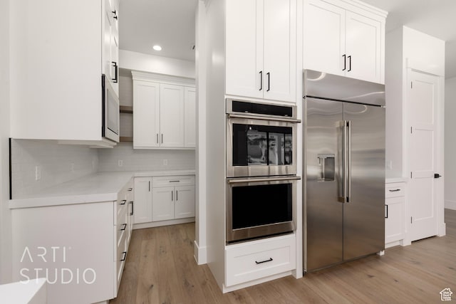 2832 E Stonedale Dr, St George, UT 84790 - kitchen featuring stainless steel appliances, light wood-style flooring, white cabinets, backsplash, and recessed lighting