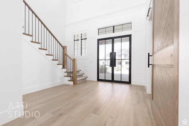 2832 E Stonedale Dr, St George, UT 84790 - doorway to outside featuring french doors, stairs, light wood-style floors, a high ceiling, and baseboards