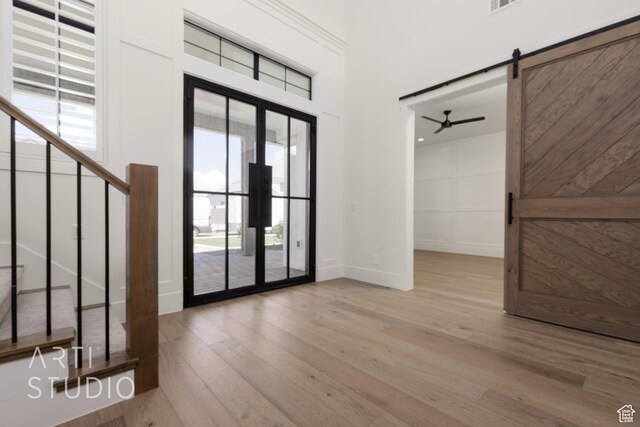 2832 E Stonedale Dr, St George, UT 84790 - entryway featuring wood finished floors, baseboards, a ceiling fan, a barn door, and stairway