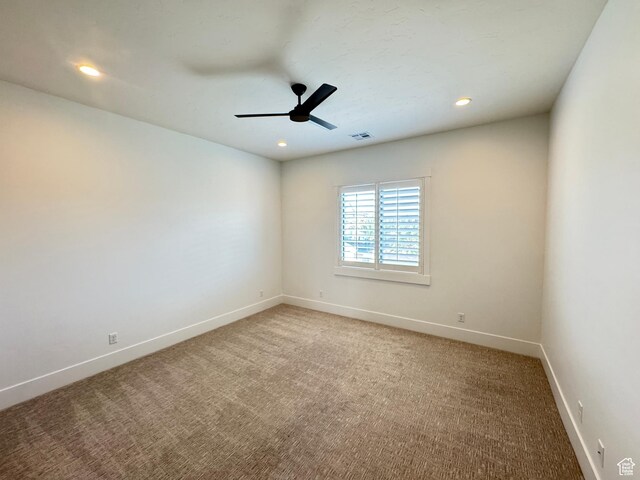 spare room with baseboards, light carpet, ceiling fan, and recessed lighting