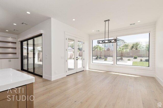 2832 E Stonedale Dr, St George, UT 84790 - unfurnished dining area featuring french doors, baseboards, light wood-style floors, built in features, and recessed lighting