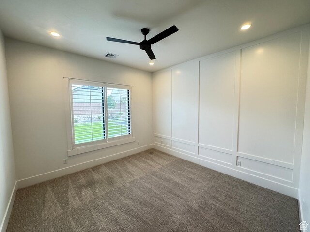 empty room featuring a ceiling fan, carpet floors, recessed lighting, baseboards, and a decorative wall