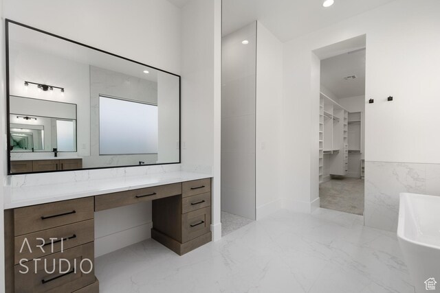 2832 E Stonedale Dr, St George, UT 84790 - full bath with marble tiled flooring, a freestanding tub, vanity, a spacious closet, and recessed lighting