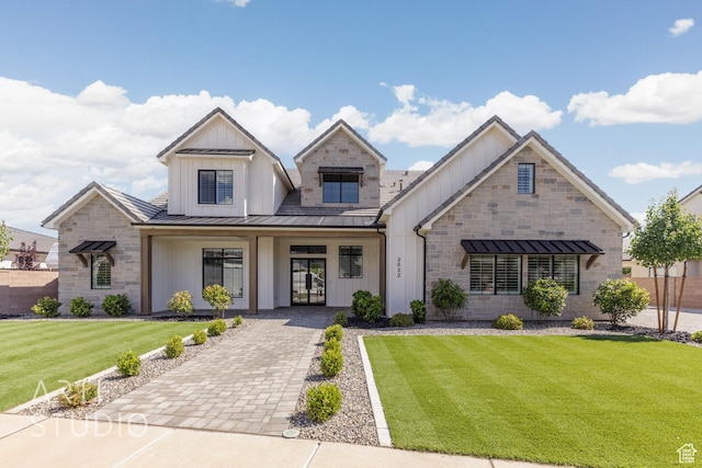 2832 E Stonedale Dr, St George, UT 84790 - view of front of home featuring a standing seam roof, a front yard, board and batten siding, and french doors