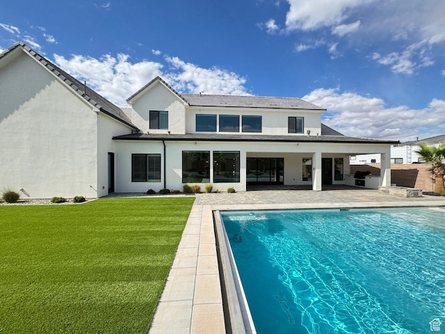 2832 E Stonedale Dr, St George, UT 84790 - rear view of house with a patio, stucco siding, an outdoor pool, and a yard