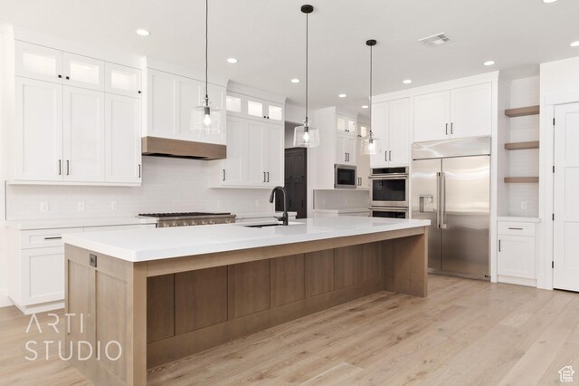 2832 E Stonedale Dr, St George, UT 84790 - kitchen with stainless steel appliances, a sink, backsplash, white cabinets, and light countertops