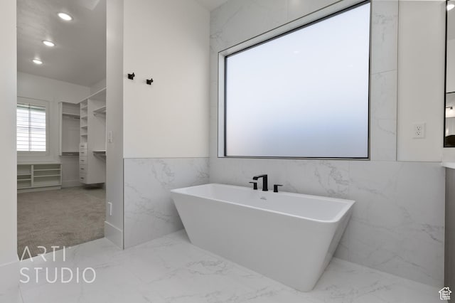 2832 E Stonedale Dr, St George, UT 84790 - bathroom with marble finish flooring, a soaking tub, tile walls, and recessed lighting
