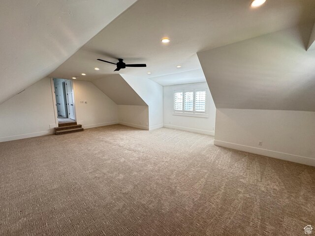bonus room featuring vaulted ceiling, light carpet, baseboards, recessed lighting, and ceiling fan