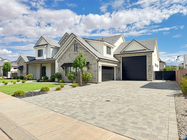 2832 E Stonedale Dr, St George, UT 84790 - view of front of property with decorative driveway, board and batten siding, a garage, and stone siding