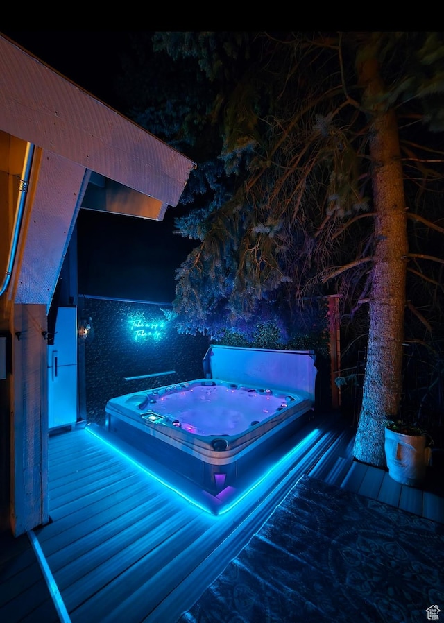 5925 W Highland Dr N, Mountain Green, UT 84050 - pool at night featuring a covered hot tub