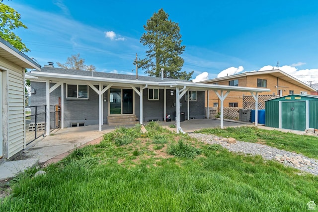 172 E 400 N, Tooele, UT 84074 - back of property featuring a patio area, a storage shed, brick siding, and an outdoor structure
