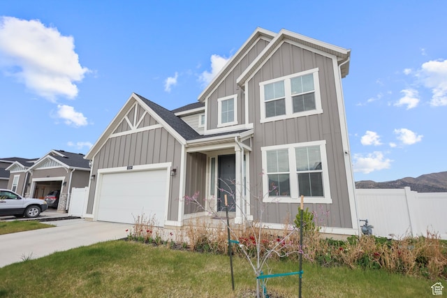 view of front of property featuring board and batten siding, driveway, and an attached garage