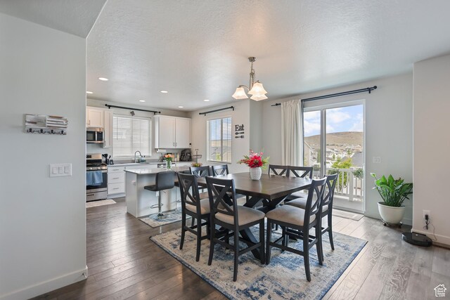 6366 N Wanlass Hl, Eagle Mountain, UT 84005 - dining area featuring hardwood / wood-style flooring, baseboards, a textured ceiling, and recessed lighting