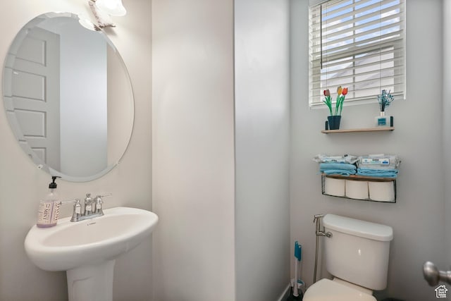 bathroom featuring toilet and a sink