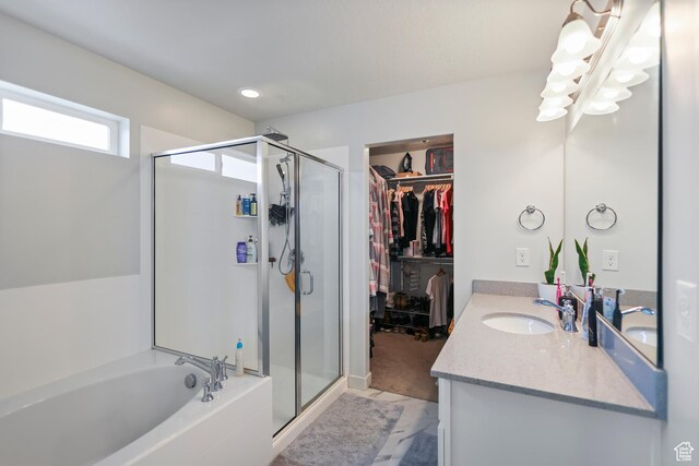 6366 N Wanlass Hl, Eagle Mountain, UT 84005 - bathroom with a shower stall, a bath, vanity, a walk in closet, and recessed lighting
