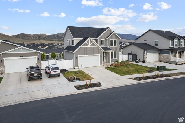 6366 N Wanlass Hl, Eagle Mountain, UT 84005 - view of front of house featuring board and batten siding, a residential view, fence, a mountain view, and driveway