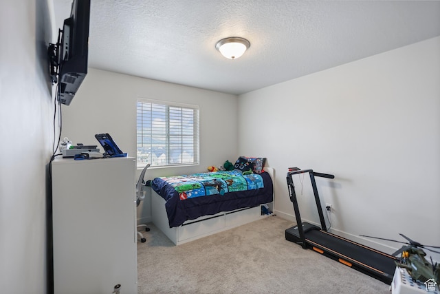 bedroom with carpet and a textured ceiling