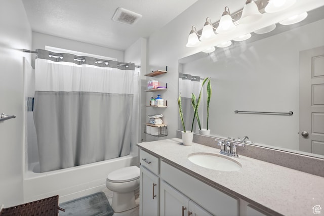 full bath with shower / tub combo, vanity, and toilet