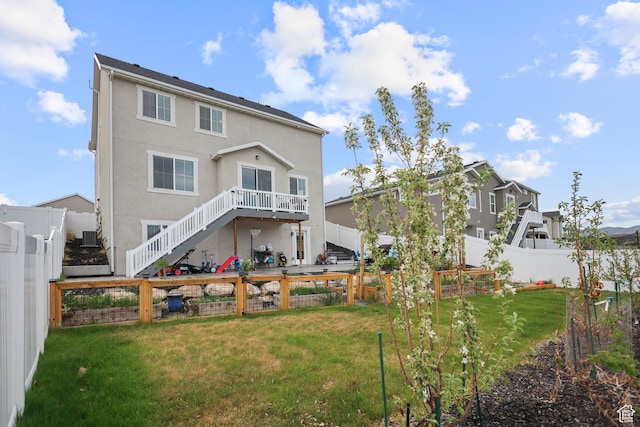 rear view of property featuring stairs and stucco siding