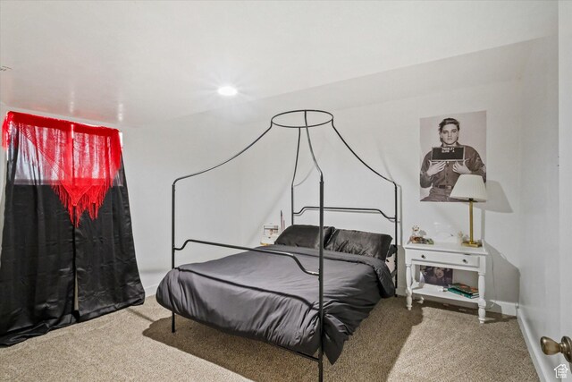 bedroom featuring carpet flooring and baseboards