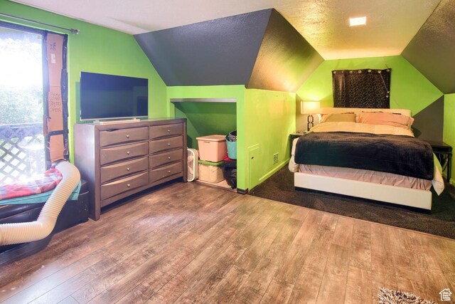 bedroom with hardwood / wood-style flooring and vaulted ceiling