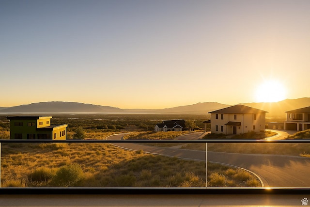 view of front facade with a mountain view and a balcony