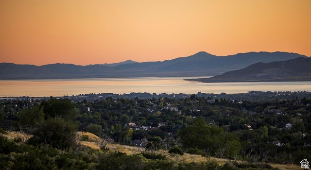 view of mountain backdrop featuring a nearby body of water