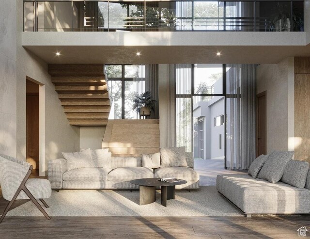 living area with a high ceiling and wood finished floors