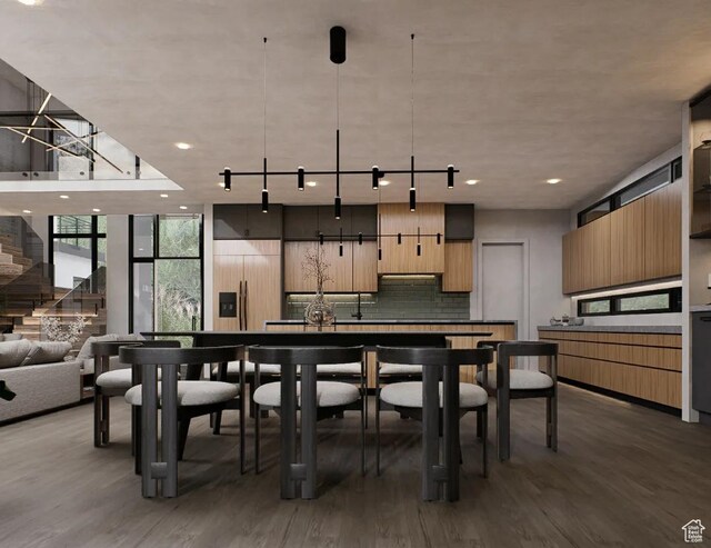 kitchen featuring built in fridge, wood finished floors, expansive windows, modern cabinets, and backsplash