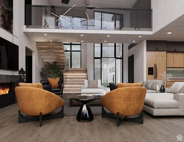 common area with a towering ceiling, stairs, and recessed lighting