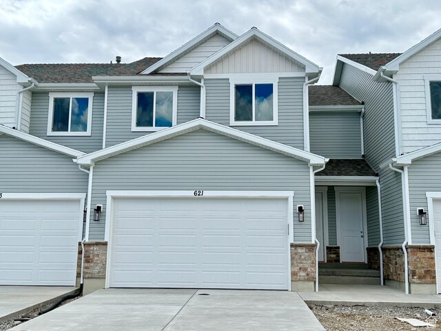 621 S 85 E Unit 24, Smithfield, UT 84335 - multi unit property with concrete driveway, stone siding, an attached garage, and a shingled roof