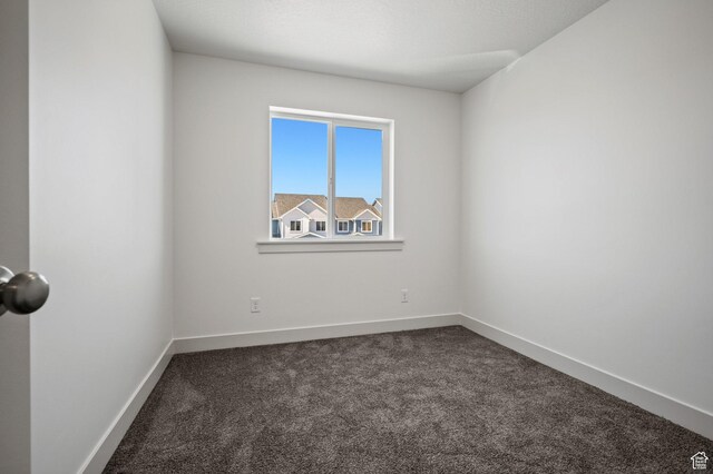 621 S 85 E Unit 24, Smithfield, UT 84335 - empty room featuring dark colored carpet and baseboards
