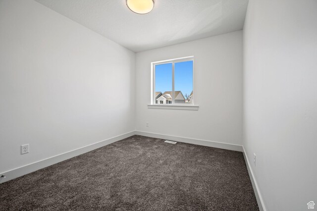 621 S 85 E Unit 24, Smithfield, UT 84335 - empty room with dark carpet and baseboards