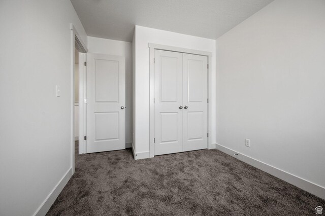 621 S 85 E Unit 24, Smithfield, UT 84335 - unfurnished bedroom with carpet floors, baseboards, and a closet