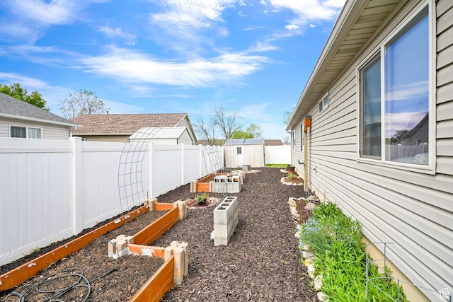 157 W Southwell St, Ogden, UT 84404 - fenced backyard with a garden, a shed, and an outdoor structure
