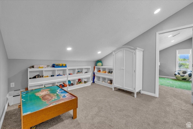 recreation room featuring vaulted ceiling, carpet floors, a textured ceiling, recessed lighting, and baseboards