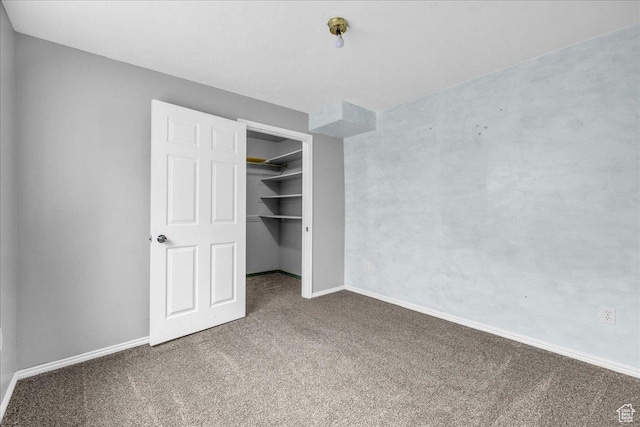 unfurnished bedroom with carpet floors, a closet, and baseboards