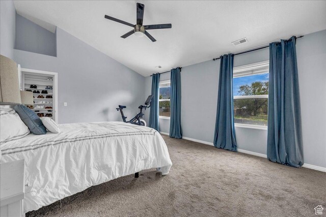 carpeted bedroom with lofted ceiling, baseboards, and a ceiling fan