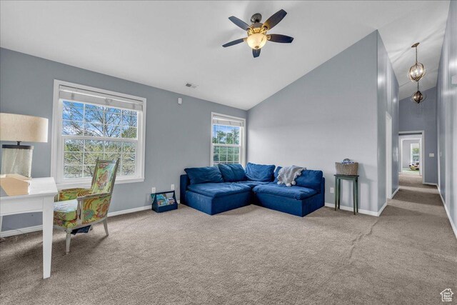 carpeted living room with ceiling fan, baseboards, and high vaulted ceiling