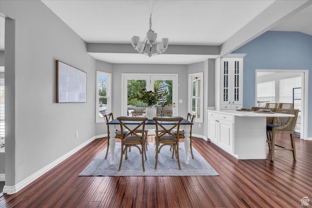 dining room with a chandelier, dark wood finished floors, and baseboards