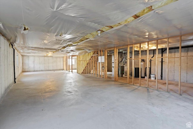 below grade area featuring heating unit and a water softener system