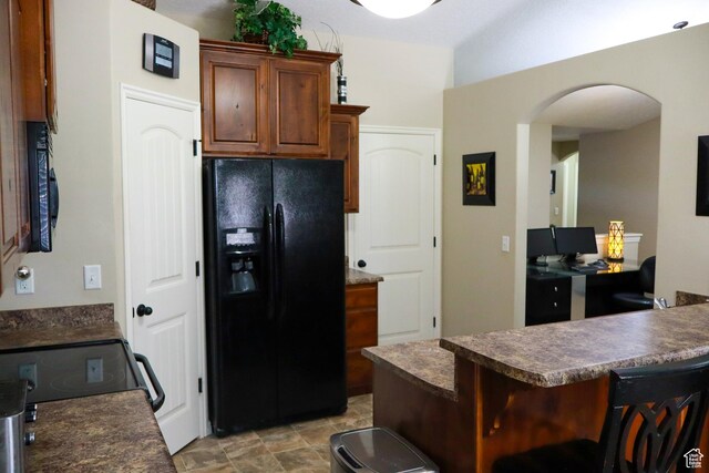 1661 S 1960 E, Spanish Fork, UT 84660 - kitchen featuring black appliances, arched walkways, dark countertops, and an office area