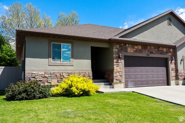 1661 S 1960 E, Spanish Fork, UT 84660 - view of front of house with stone siding, stucco siding, an attached garage, driveway, and a shingled roof