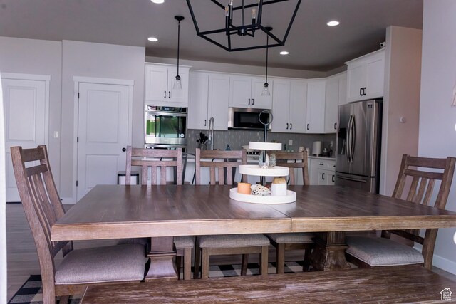 14944 S Beckham Dr W, Herriman, UT 84096 - dining space with recessed lighting, a chandelier, and dark wood-style flooring