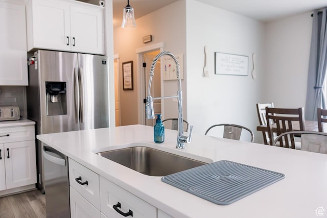 14944 S Beckham Dr W, Herriman, UT 84096 - kitchen featuring stainless steel fridge with ice dispenser, light countertops, a sink, white cabinetry, and light wood-type flooring