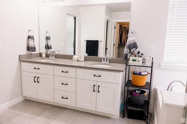 14944 S Beckham Dr W, Herriman, UT 84096 - bathroom with double vanity, tile patterned floors, baseboards, and a spacious closet