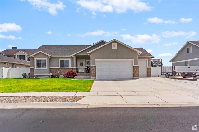 craftsman house featuring an attached garage, stucco siding, driveway, and brick siding