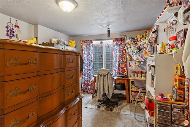 bedroom featuring carpet and a textured ceiling